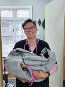 Sandra holding a pup after a successful surgery