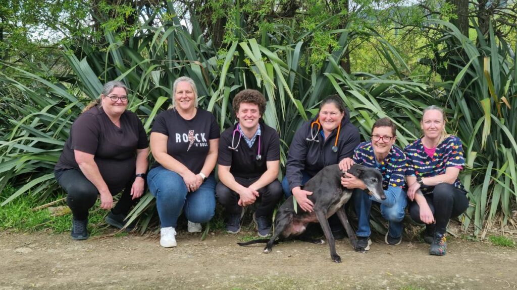 Team photo crouched around our greyhound Trophy